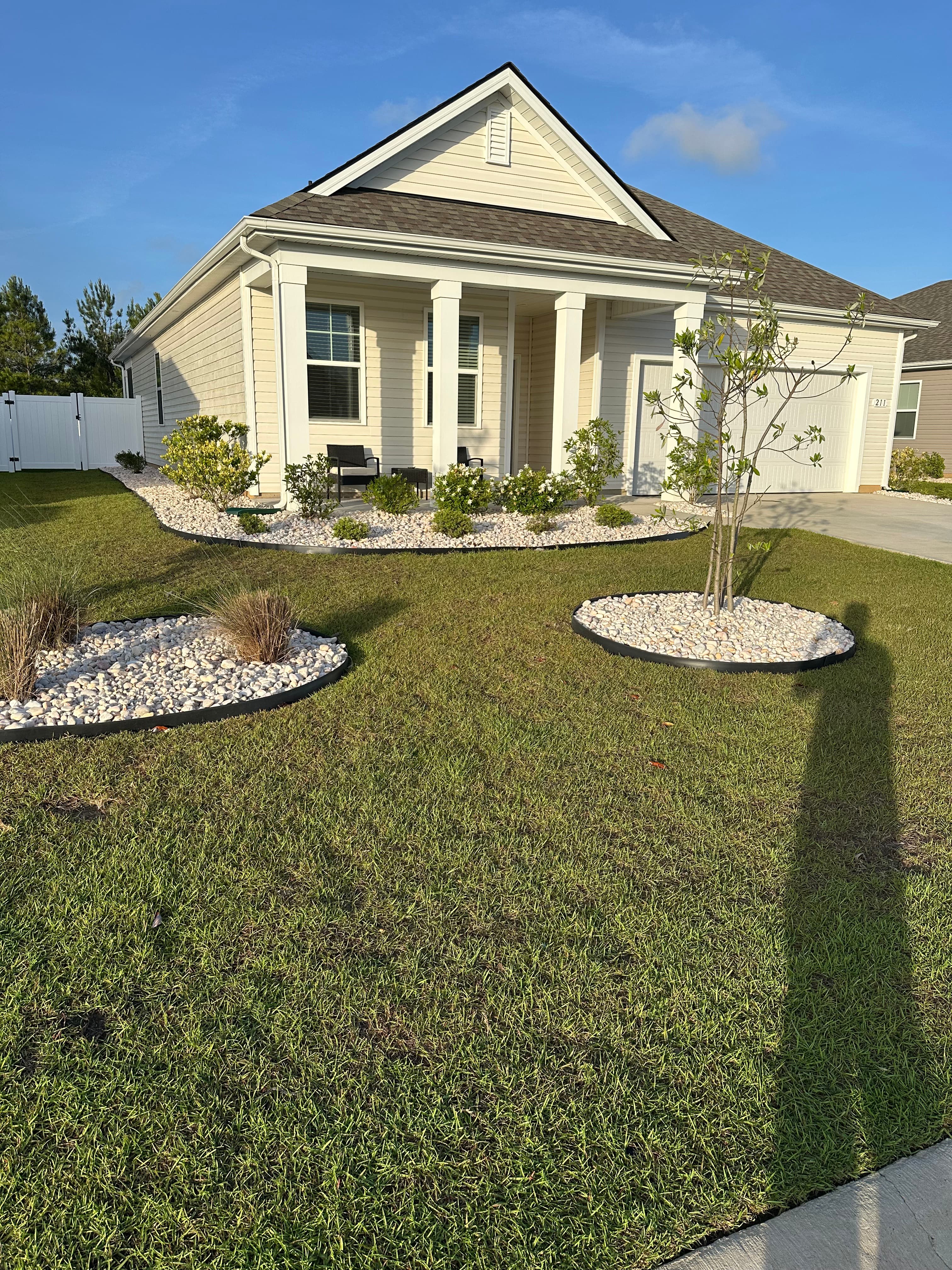 Front yard landscape refresh with white rock beds and mulch